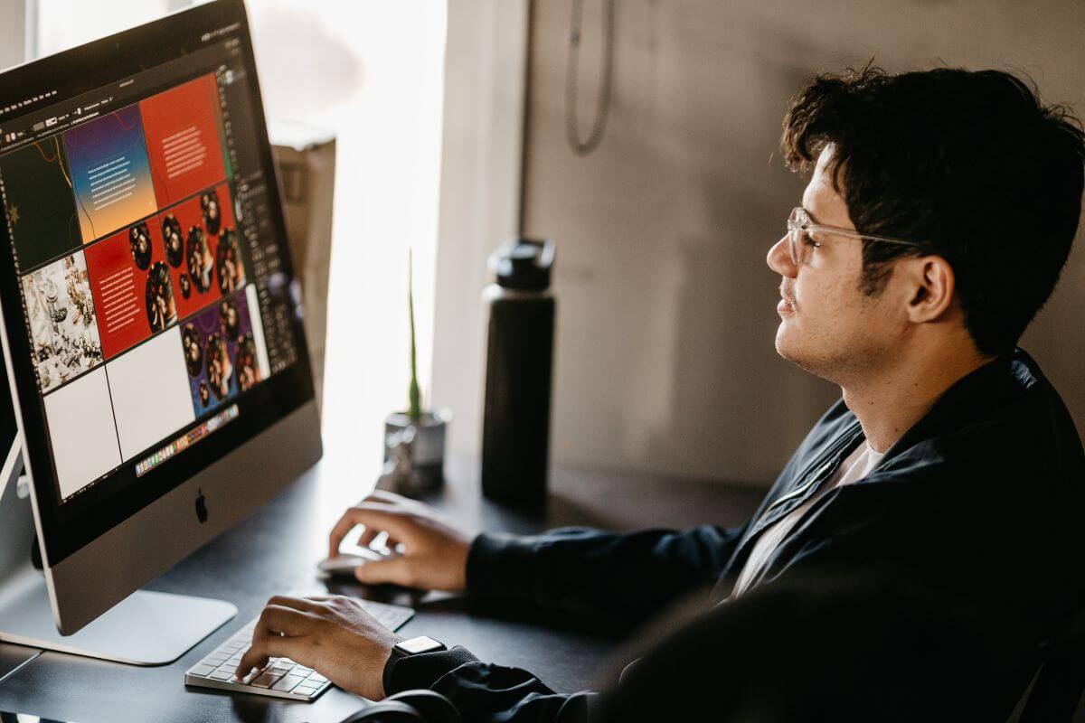 PeoplePartners graphic designer and marketing coordinator working in front of a computer